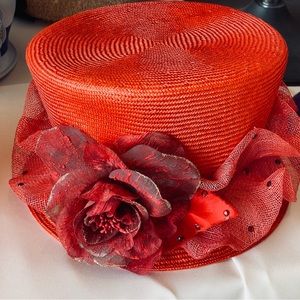 Red cloche straw hat with red flower accented with red crystals